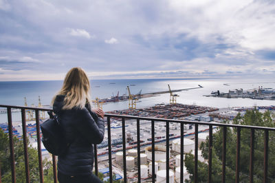 Woman looking at sea against sky