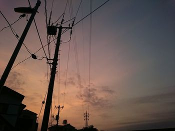 Low angle view of electricity pylon against sky