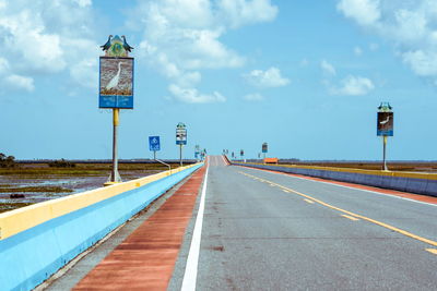 Road sign against sky