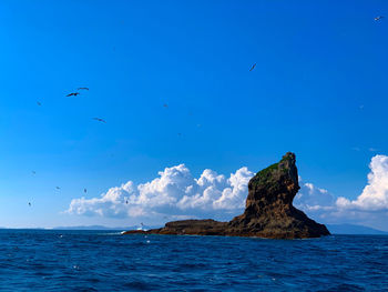 Scenic view of sea against blue sky