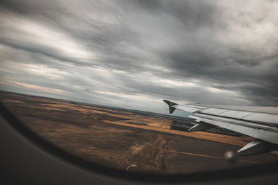 Airplane wing against sky