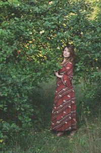 Woman standing by tree