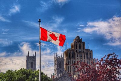 Low angle view of american flag against sky