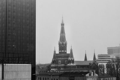 Buildings in city against clear sky