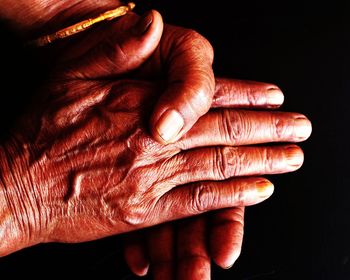 Close-up of senior person showing wrinkles on hand