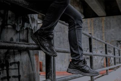 Low section of man standing on staircase