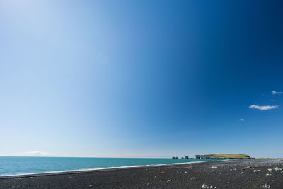 Scenic view of sea against blue sky