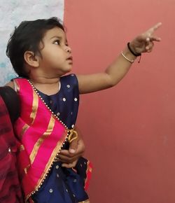 Full length of a girl holding red wall