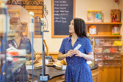 Young pretty woman shopping in a bakery