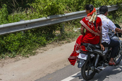 People riding motorcycle on road