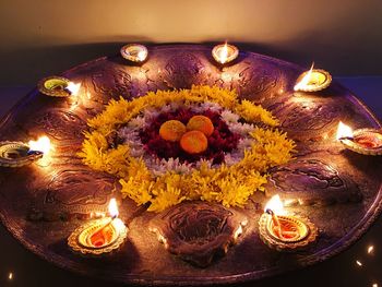 High angle view of illuminated candles on flower