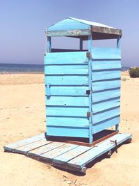 Lifeguard hut on beach against sky