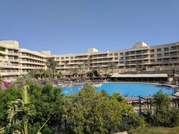 View of buildings against clear blue sky