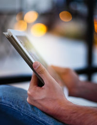 Midsection of man using digital tablet