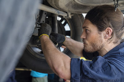 Portrait of man holding camera in car