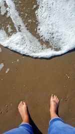 Low section of woman standing on beach