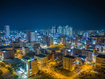 Aerial view of city lit up at night