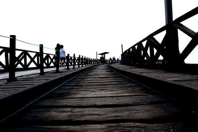 Man walking on footbridge