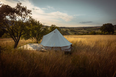 Tent on field against sky