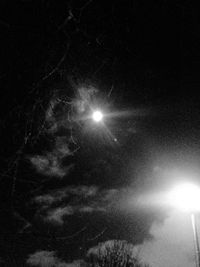 Low angle view of illuminated street light against sky