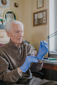 Man sitting on chair at home