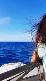 Woman looking at sea against sky