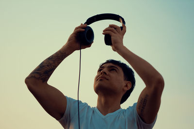 Young man holding headphones
