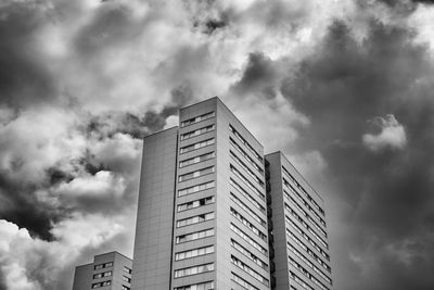 Low angle view of buildings against cloudy sky