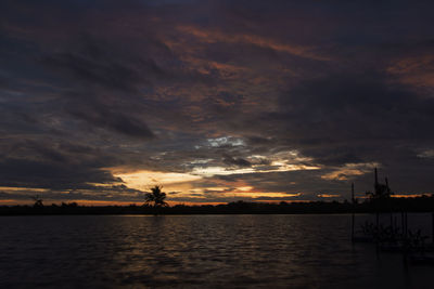Scenic view of sea against dramatic sky during sunset
