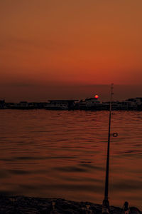 Scenic view of sea against orange sky
