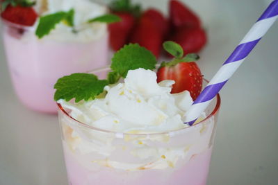 Strawberry milkshake with whipped cream in glass