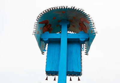 Low angle view of cross against clear blue sky