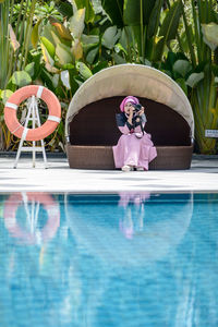 Reflection of woman in swimming pool