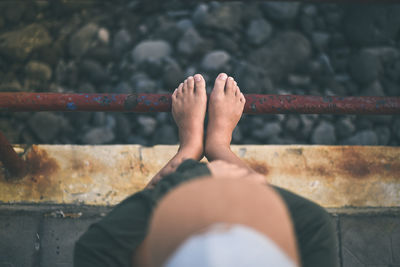 Low section of man legs on railing