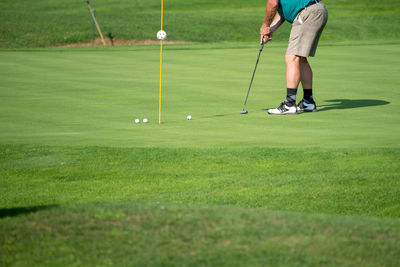 Low section of woman standing on golf course