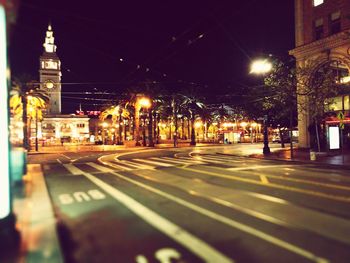 Illuminated street and buildings at night