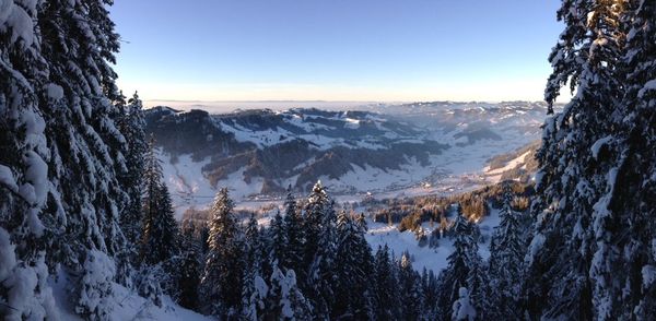 Scenic view of snowcapped mountains against clear sky