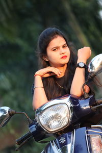 Portrait of young woman with bike