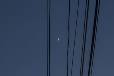 Low angle view of moon against clear sky