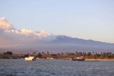 Scenic view of sea against buildings in city