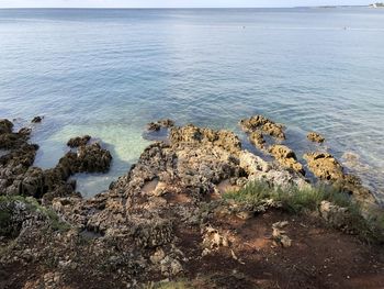 High angle view of rocks on shore against sea