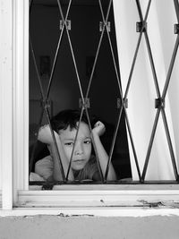 Boy looking through window