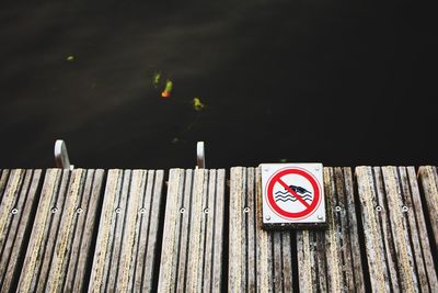 Close-up of warning sign on wood