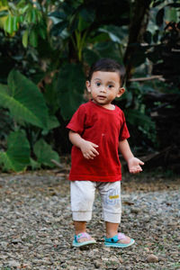 Portrait of cute boy standing outdoors