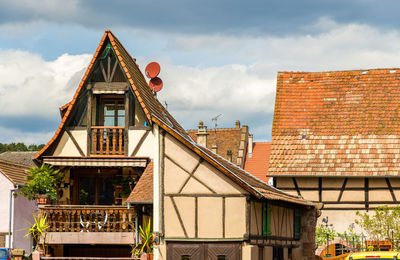 Low angle view of old building in town against sky