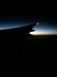 Aerial view of airplane flying in sky at night