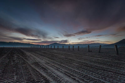 Scenic view of beach against sky during sunset