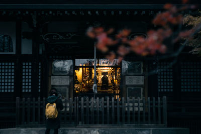 Woman standing in city at night