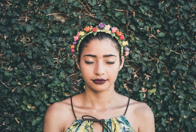 Portrait of a beautiful young woman with eyes closed