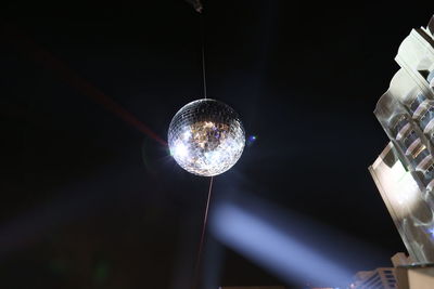 Low angle view of disco ball at night